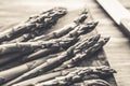 Fresh uncooked asparagus on a wooden cutting board. Close up view.