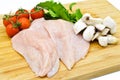 Fresh uncooked chicken meat breast pieces, ready to cook, with tomatoes greens and mushrooms Royalty Free Stock Photo