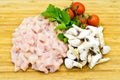 Fresh uncooked chicken meat breast pieces, ready to cook, with tomatoes greens and mushrooms Royalty Free Stock Photo