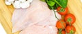Fresh uncooked chicken meat breast pieces, ready to cook, with tomatoes greens and mushrooms Royalty Free Stock Photo