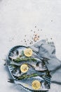 Fresh uncooked dorado or sea bream fish with lemon, herbs, oil, vegetables and spices on concrete background. Top view Royalty Free Stock Photo