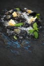 Fresh uncooked mussels with lemon, herbs and spices on chipped ice over dark slate stone backdrop Royalty Free Stock Photo