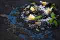 Fresh uncooked mussels with lemon, herbs and spices on chipped ice over dark slate stone backdrop Royalty Free Stock Photo