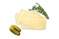 Fresh Uncooked Raclette Swiss cheese slices on marble board Isolated on white background.