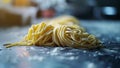 Fresh uncooked spaghetti pasta on floured surface