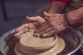 Ceramic plate on a potter's wheel, ceramist's hands. Royalty Free Stock Photo
