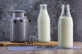Fresh unpasteurized milk in a old milk jug and two glass bottle Royalty Free Stock Photo