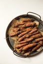 Fresh unwashed carrots in a metal tray