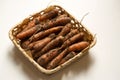 Fresh unwashed carrots in a square basket