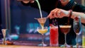 Fresh up your night. Close up of hands of male bartender pouring, mixing ingredients while making cocktails, alcoholic Royalty Free Stock Photo