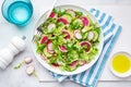 Fresh vegan watermelon radish and cucumber salad on white plate