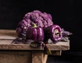 Fresh vegetable. Dark purple peppers, cauliflower with leaves of basil Royalty Free Stock Photo