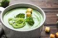 Fresh vegetable detox soup made of broccoli with croutons in dish on table