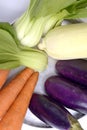 Fresh vegetable of eggplant, carrot, mustard pakcoy, and raw corn in the glass bowl