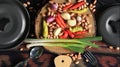 Fresh vegetable ingredients with kitchen utensils ready to cook.