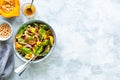 Fresh vegetable and pumpkin salad in a plate on a white stone background. Top view Royalty Free Stock Photo