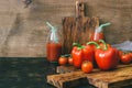 Fresh vegetable red peppers and cherry tomatoes, tomato juice on wooden table, rustic style. Selective focus. Royalty Free Stock Photo