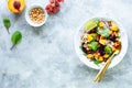 Fresh vegetable salad with beets, arugula, red onions, sorrel, chickpeas, peaches and grapes in a white plate on a white Royalty Free Stock Photo