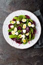 Fresh vegetable salad with boiled beet, mangold leaves, walnuts and quail eggs