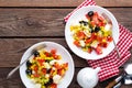 Fresh vegetable salad bowls of tomatoes, corn, pepper, olives, celery, green onion and feta cheese. Healthy food. Diet dinner or l Royalty Free Stock Photo