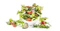 Fresh vegetable salad with fried bacon tomatoes olives arugula zucchini tzatziki dressing and olive oil isolated on white