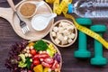 Fresh vegetable salad and healthy food for sport equipment for women diet slimming with measure tap for weight loss on wood backgr Royalty Free Stock Photo