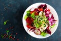 Fresh vegetable salad plate of tomatoes, italian mix, pepper, radish, green sprouts and flax seeds. Vegetarian dish, healthy food. Royalty Free Stock Photo