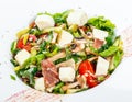 Fresh vegetable salad with prosciutto, spinach, mushrooms, tomatoes, cheese, onions, cucumbers Royalty Free Stock Photo