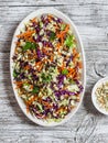 Fresh vegetable salad with red cabbage, carrots, sweet peppers, herbs and seeds. Healthy vegetarian food. Royalty Free Stock Photo