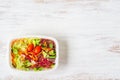 Fresh vegetable salad on rusty white wood. Healthy eating concept. Lunch box, take away organic food. Weight loss diet. Flat lay Royalty Free Stock Photo