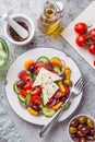 Fresh vegetable salad  tomato, cucumber, bel pepper, olives  and feta cheese in white plate Royalty Free Stock Photo