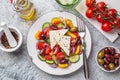Fresh vegetable salad  tomato, cucumber, bel pepper, olives  and feta cheese in white plate Royalty Free Stock Photo