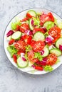 Fresh vegetable salad with tomatoes, cucumbers, sweet pepper and sesame seeds. Vegetable salad on white plate Royalty Free Stock Photo