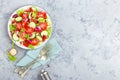 Fresh vegetable salad with tomatoes, cucumbers, sweet pepper and sesame seeds. Vegetable salad on white plate Royalty Free Stock Photo