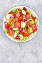 Fresh vegetable salad with tomatoes, cucumbers, sweet pepper and sesame seeds. Vegetable salad on white plate Royalty Free Stock Photo