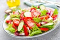 Fresh vegetable salad with tomatoes, cucumbers, sweet pepper and sesame seeds. Vegetable salad on white plate Royalty Free Stock Photo