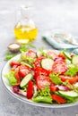 Fresh vegetable salad with tomatoes, cucumbers, sweet pepper and sesame seeds. Vegetable salad on white plate Royalty Free Stock Photo