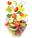 Fresh vegetable salad. Vegetables falling into a bowl with salad on a white, isolated.