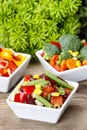 Fresh vegetable salad in white bowl. Spring party table. Royalty Free Stock Photo