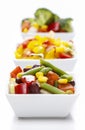 Fresh vegetable salad in white bowl. Spring party table. Royalty Free Stock Photo