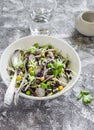 Fresh vegetable salad with white and red cabbage, cucumber, radish and cilantro in a ceramic dish on a stone texture. Royalty Free Stock Photo