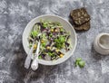 Fresh vegetable salad with white and red cabbage, cucumber, radish and cilantro in a ceramic dish on a stone texture. Royalty Free Stock Photo