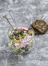 Fresh vegetable salad with white and red cabbage, cucumber, radish and cilantro in a glass jar on a stone texture. Royalty Free Stock Photo