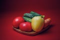 Fresh vegetable set on a bamboo plate. on red background