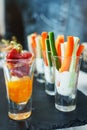 Fresh vegetable sticks and meat with sauce in a glass. Snacks and canaps.