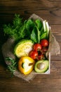 Fresh vegetable on wooden background. Tomatoes, cabbage, pepper, green onion, avocado, dill and parsley. Top views, close-up Royalty Free Stock Photo