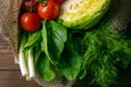 Fresh vegetable on wooden background. Tomatoes, cabbage, pepper, green onion, avocado, dill and parsley. Top views, close-up Royalty Free Stock Photo