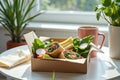 Fresh vegetable wraps with greens and radishes in eco-friendly box on sunny table Royalty Free Stock Photo