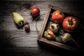 Fresh vegetables in a burned rustic texture box for background. Rough weathered wooden board. Toned Royalty Free Stock Photo