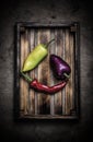 Fresh vegetables in a burned rustic texture box for background. Rough weathered wooden board. Toned Royalty Free Stock Photo